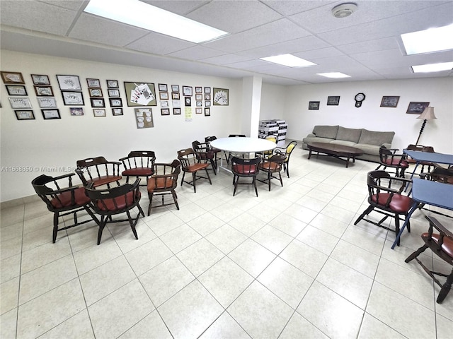 tiled dining room with a paneled ceiling