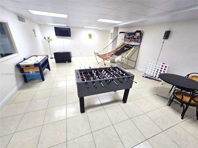 rec room featuring a drop ceiling and light tile patterned floors