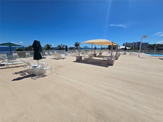 view of home's community featuring a pool and a patio area