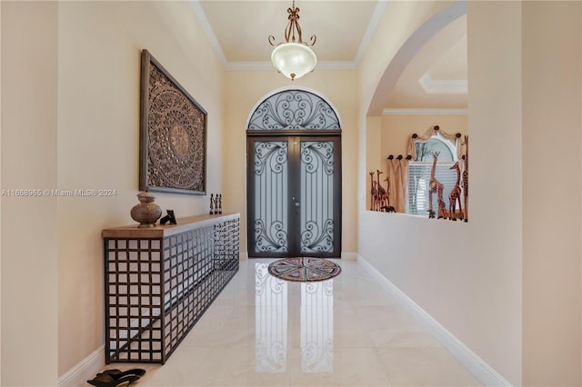 foyer entrance with french doors and crown molding