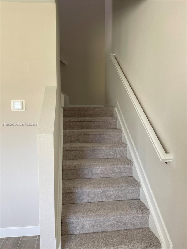 stairway featuring hardwood / wood-style floors