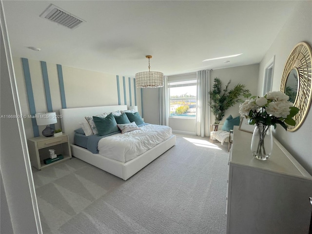 bedroom featuring visible vents and light carpet