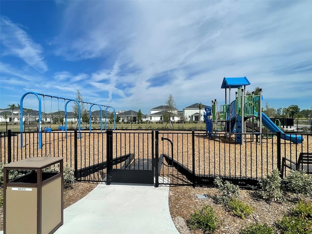 community play area featuring a gate and fence