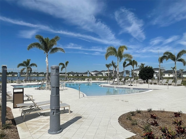 community pool featuring a patio and fence