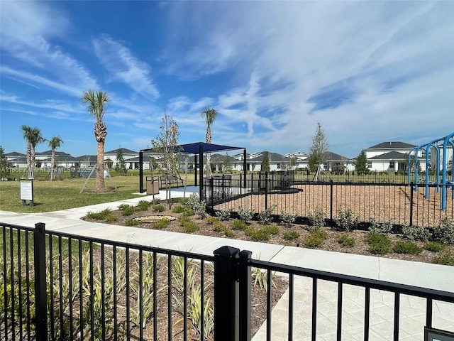 view of home's community featuring a yard, fence, and a residential view