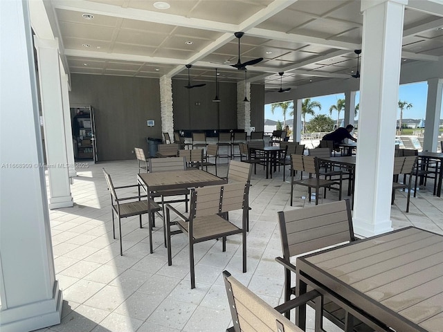 view of patio with outdoor dining space and a ceiling fan