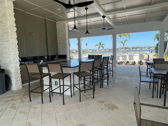 view of patio with outdoor wet bar and ceiling fan