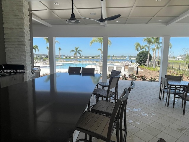 view of patio / terrace featuring outdoor dining area, a ceiling fan, and a community pool