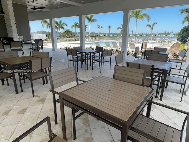 view of patio featuring outdoor dining space and a community pool