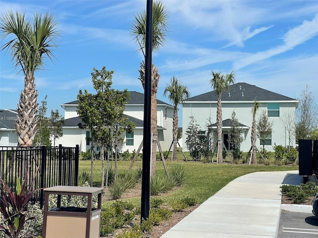 view of community with a yard and fence