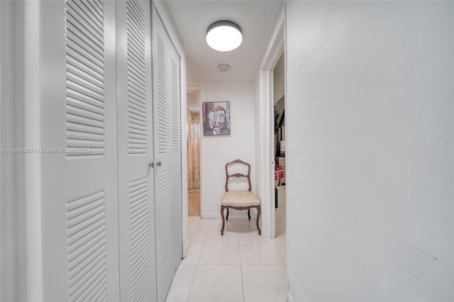 hall with light tile patterned floors