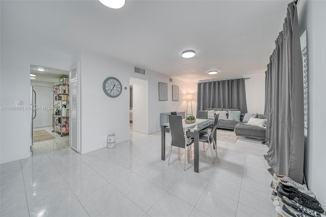 dining space featuring light tile patterned flooring