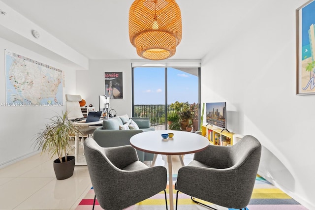 dining area featuring tile patterned floors and a wall of windows