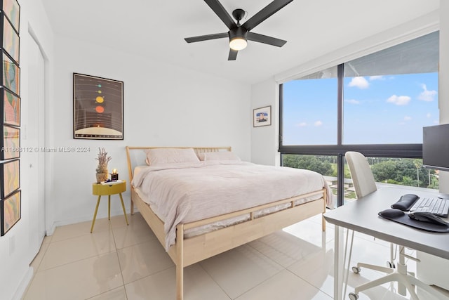 tiled bedroom with multiple windows and ceiling fan