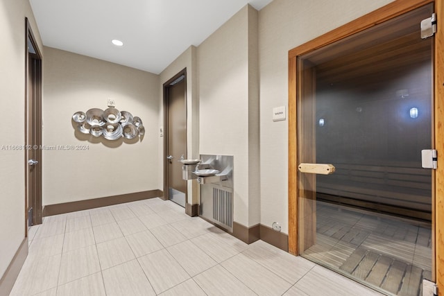 hallway featuring light tile patterned floors