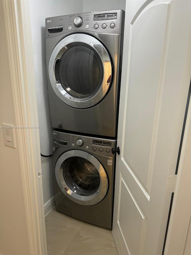 laundry room featuring stacked washer / drying machine