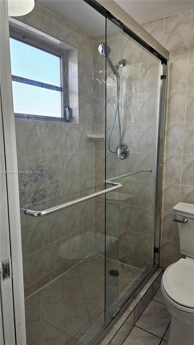 bathroom with walk in shower and toilet