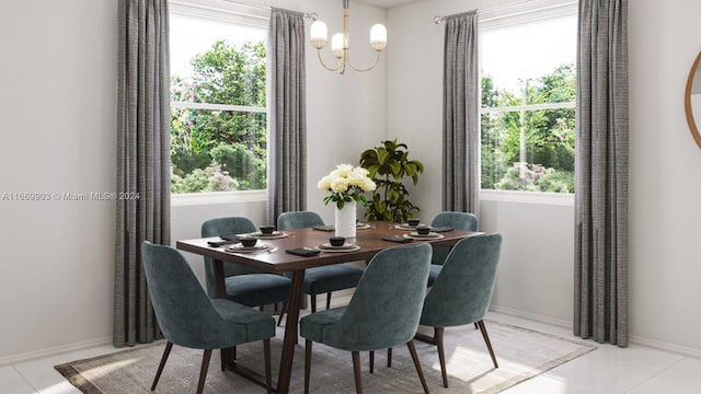 dining space featuring a notable chandelier, light tile patterned flooring, and a wealth of natural light