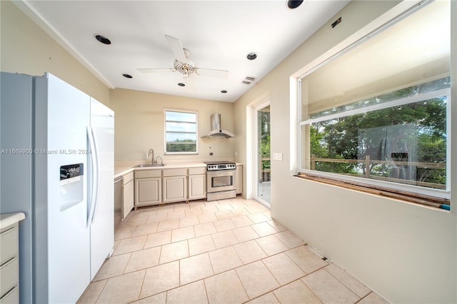 kitchen with stainless steel electric stove, wall chimney exhaust hood, light tile patterned floors, white fridge with ice dispenser, and sink