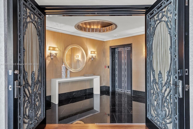 bathroom featuring crown molding and tile walls