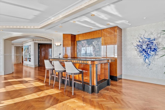 kitchen featuring light parquet floors and a breakfast bar area