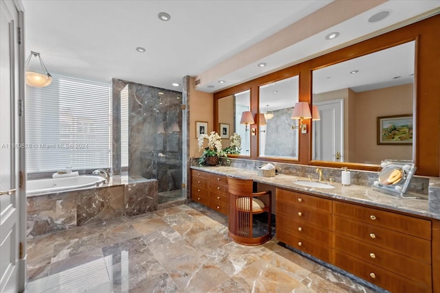 bathroom featuring vanity and independent shower and bath