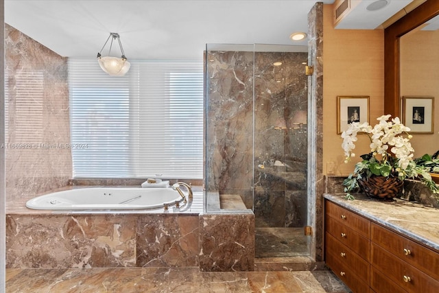 bathroom with vanity and independent shower and bath