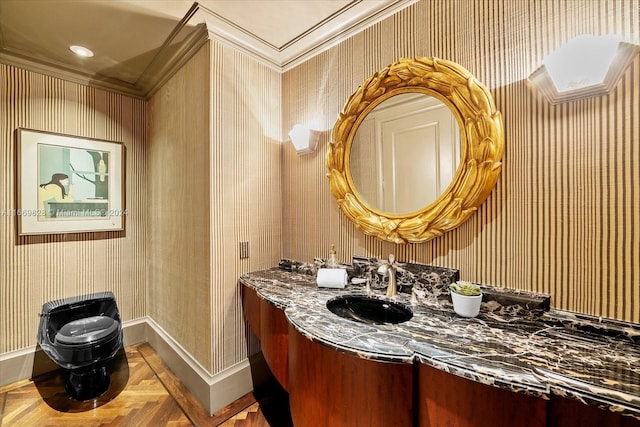 bathroom featuring vanity, ornamental molding, and parquet floors