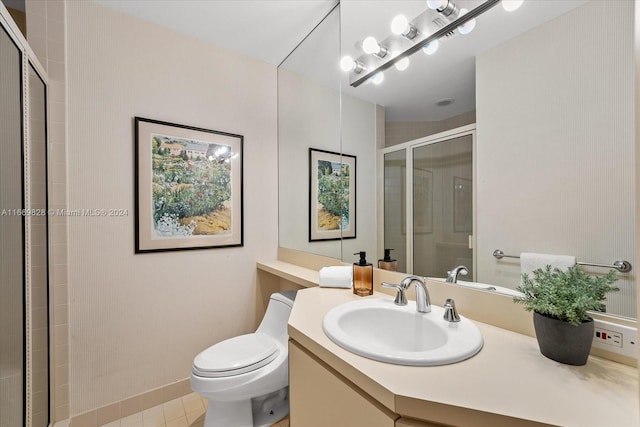 bathroom with vanity, toilet, tile patterned flooring, and an enclosed shower