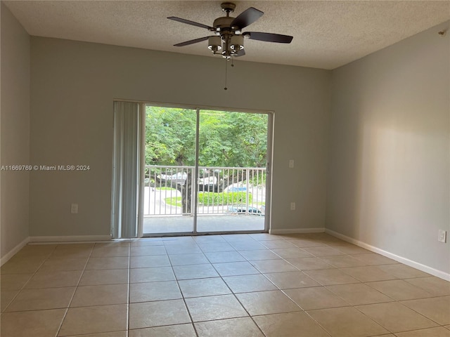 tiled spare room featuring ceiling fan and a textured ceiling