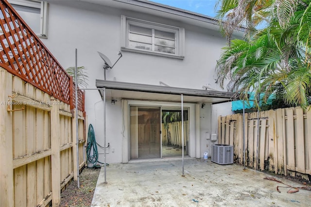 rear view of property featuring a patio and cooling unit