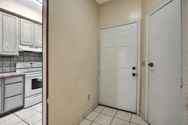 doorway with light tile patterned flooring