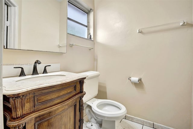 bathroom with vanity, toilet, and tile patterned floors