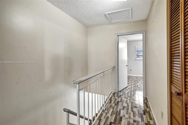 corridor featuring a textured ceiling