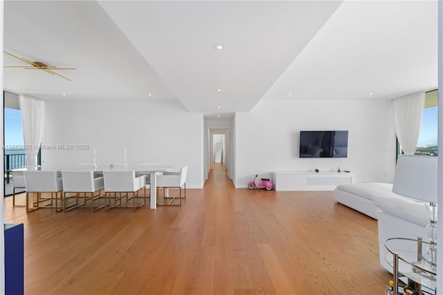 living room with expansive windows and light hardwood / wood-style flooring