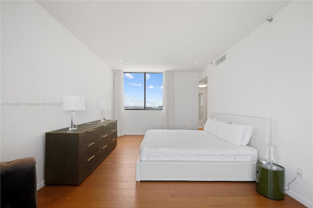 bedroom with hardwood / wood-style flooring