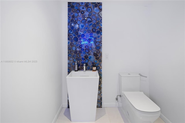 bathroom with toilet and tile patterned flooring