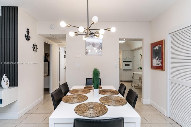 tiled dining area featuring an inviting chandelier