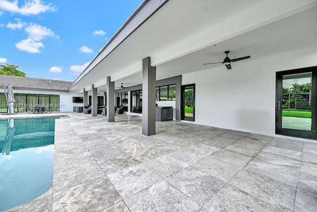 view of swimming pool featuring a patio area and ceiling fan