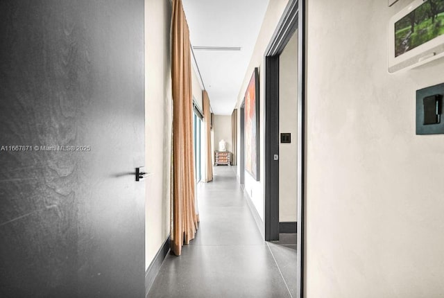 hall with concrete flooring