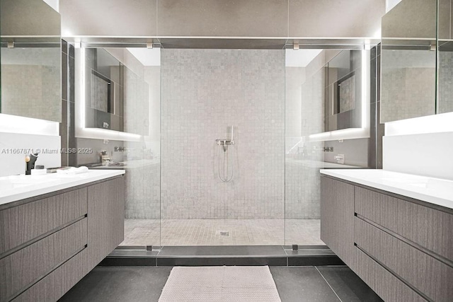 bathroom with vanity and tiled shower