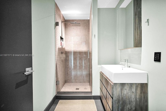 bathroom featuring walk in shower and vanity