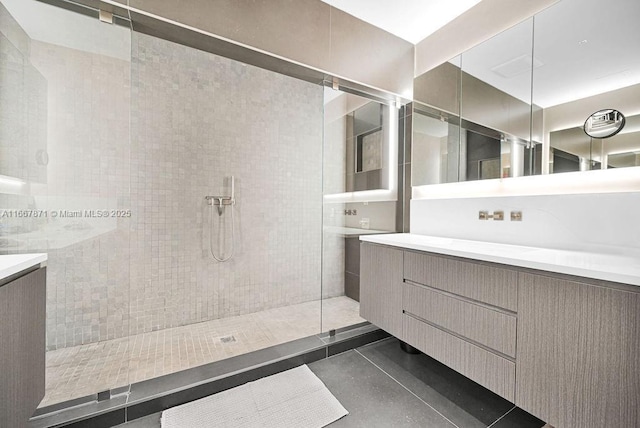 bathroom featuring vanity and tiled shower