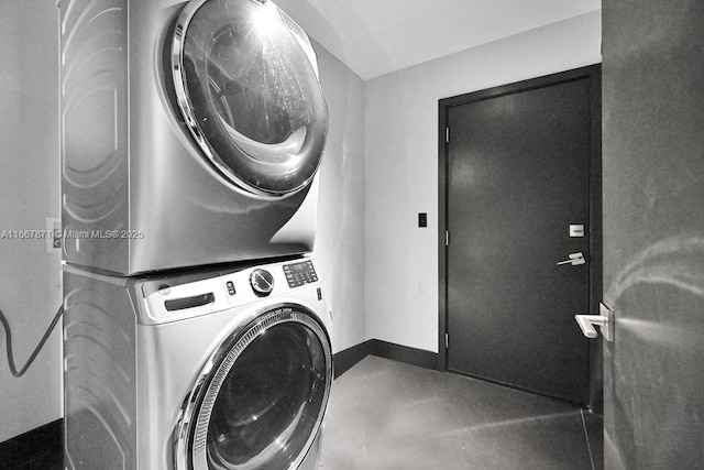 laundry room featuring stacked washer / drying machine