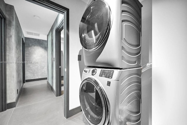 laundry area featuring stacked washer and clothes dryer