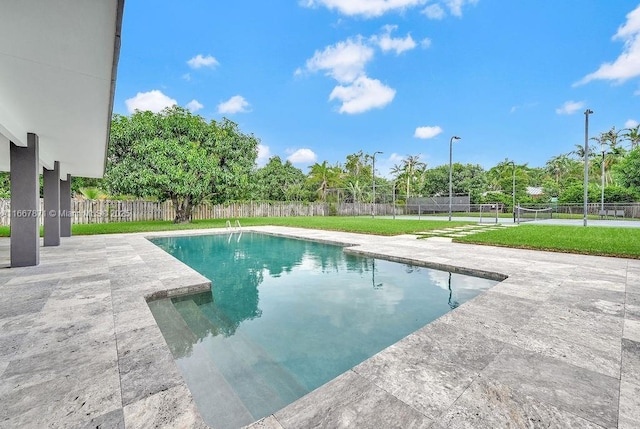 view of swimming pool with a lawn and a patio area