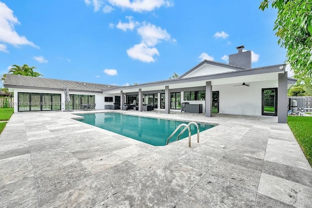 view of pool with a jacuzzi, a patio area, and ceiling fan