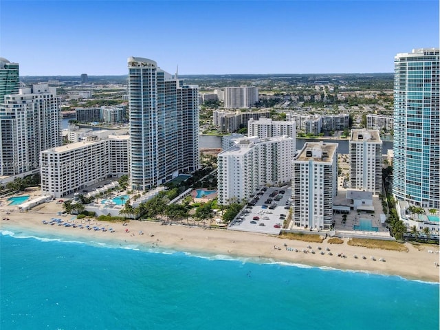 drone / aerial view with a water view and a beach view