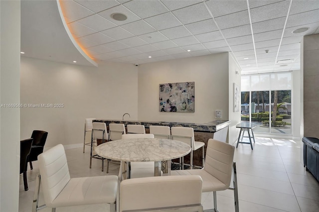 dining room featuring expansive windows, a paneled ceiling, and recessed lighting