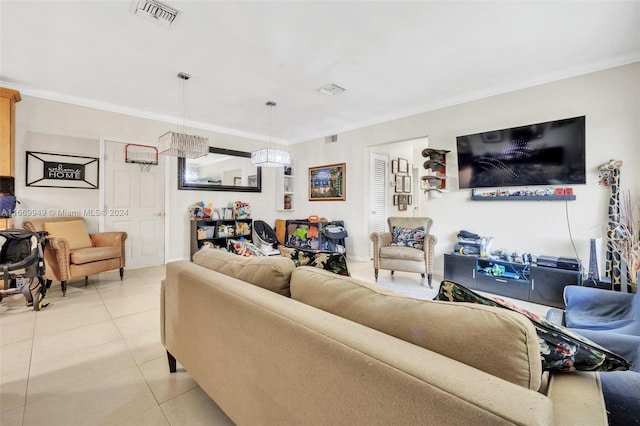 living room with light tile patterned flooring, ornamental molding, and an inviting chandelier